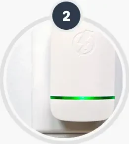 The plug-in unit seated in a wall socket with its band lit
